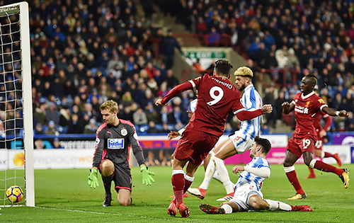 Liverpool's Roberto Firmino scores against Huddersfield Town.