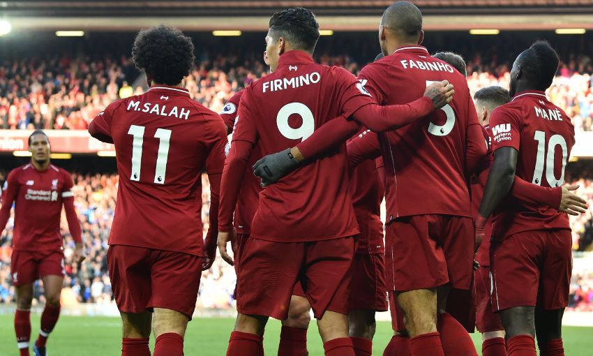 Liverpool FC players celebrate a goal versus Cardiff City at Anfield