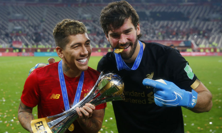 Roberto Firmino and Alisson Becker of Liverpool pose with the FIFA Club World Cup trophy following their victory in the FIFA Club World Cup Qatar 2019 Final between Liverpool FC and CR Flamengo at Education City Stadium on December 21, 2019 in Doha, Qatar.