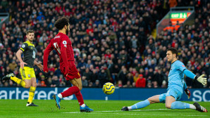 Salah lifts the ball over McCarthy