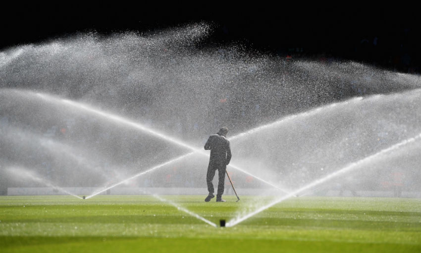 A groundsman tends to the pitch at half time during the Premier League match between Liverpool and Brighton and Hove Albion at Anfield on May 13, 2018 in Liverpool, England.