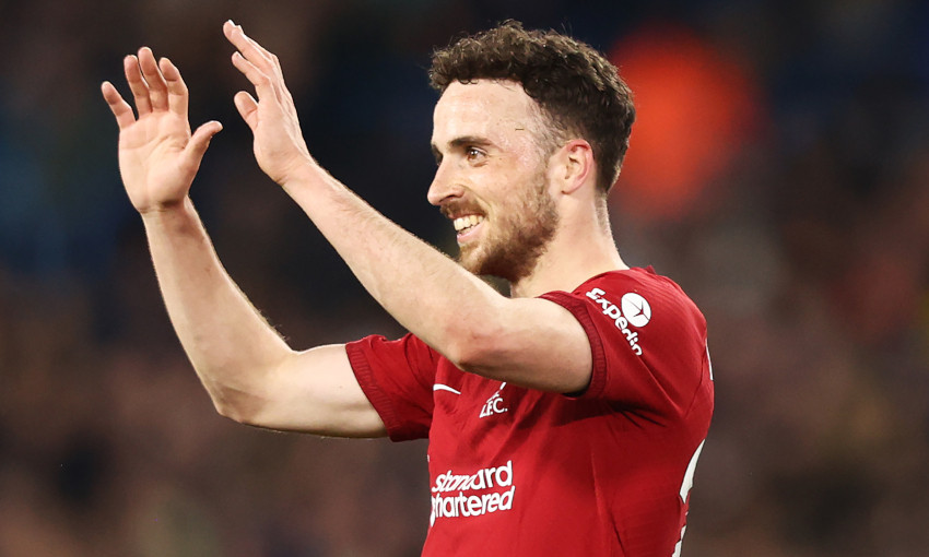 Diogo Jota raises his arms and smiles in celebration after scoring for Liverpool at Elland Road